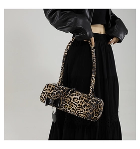 Detail of leopard print shoulder bag with black bow and heart-shaped metal charm