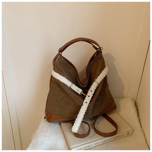 Detail of vintage brown tote bag with white fleece trim and matte leather finish