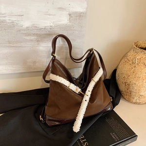 Brown vintage faux leather tote bag with white faux fur trim and adjustable shoulder strap