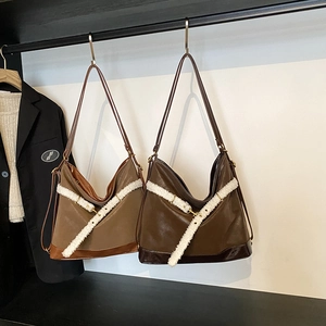 Hobo tote bag with fleece trim in light and dark brown matte leather on display