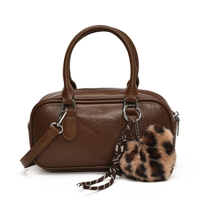 Vintage brown leather bowling bag with leopard heart charm and adjustable strap