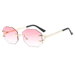 Frameless octagon sunglasses with pink gradient lenses and gold eagle claw metal frames