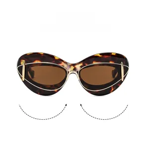 Detail view of tortoiseshell cat-eye sunglasses featuring golden heart hollowed-out temples