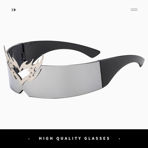 Close-up of futuristic rimless sunglasses with silver lenses and heart-shaped flame metal decor