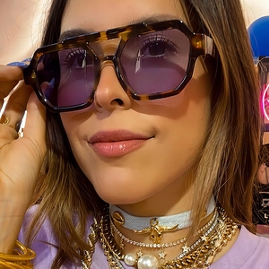 Fashionable oversized aviator sunglasses with tortoiseshell frames and purple lenses