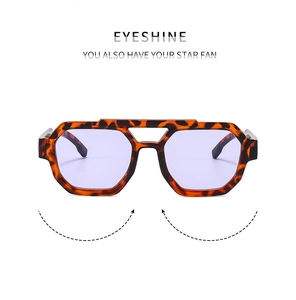 Close-up of double-bridge aviator sunglasses with tortoiseshell frame and purple lenses