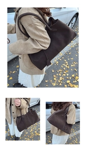 Detail of dark brown matte tote bag showing suede texture and long shoulder straps