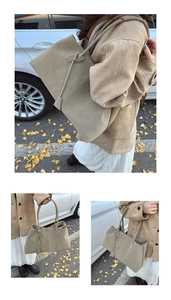 Outdoor view of a large khaki tote bag with matte texture and minimalist leather charm