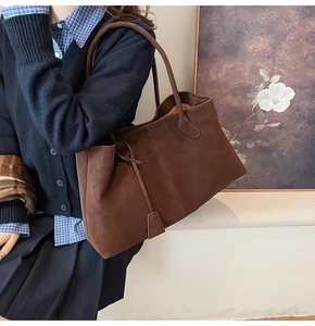 Deep brown matte tote bag shown as a crossbody with casual retro outfit styling