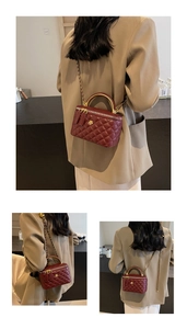 Detailed view of burgundy quilted leather vanity bag with chain strap and top metal handle