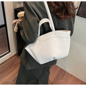 Detail view of white lychee pattern leather tote bag with unique multi-petal folding design