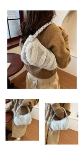 Close-up of light gray plush faux fur shoulder bag with braided strap details