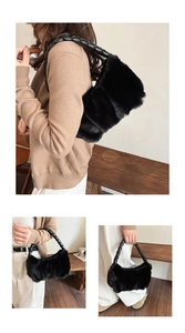 Detail of black faux fur handbag with a twisted leather shoulder strap and soft texture