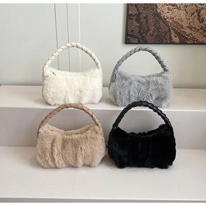 Detail of plush handbag collection in cream grey khaki and black with braided handles