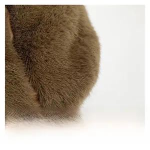 Detailed macro view showing the soft texture and sheen of brown faux fur fabric