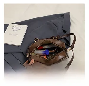Top view showing the spacious main compartment of the vintage brown boston bag with items