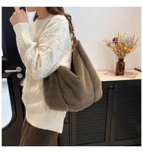 Detail of plush olive green shoulder bag with metallic rings and soft faux fur texture
