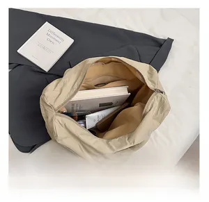Top view of spacious beige nylon tote interior with functional zipper pocket and compartments