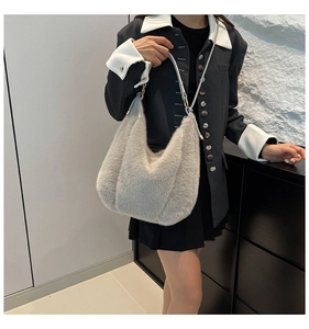 Gray plush faux fur hobo bag shown with a model wearing a stylish blazer outfit