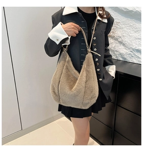 Detail of grey plush faux fur hobo bag with slim leather strap for autumn style