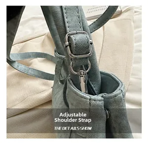 Detailed macro view of adjustable silver metal buckles and blue denim strap texture