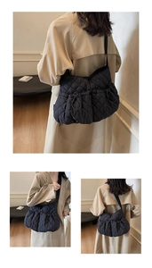 Detail der schwarzen Stepptasche mit Kordelzugtaschen und breitem Nylon-Schultergurt