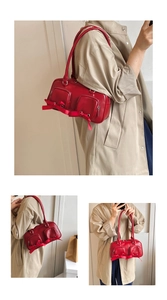 Three-way view of a red shoulder bag with ribbon bows and functional zipper pockets