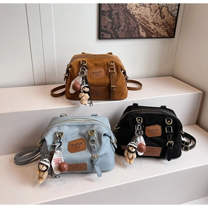 Detailed display of vintage denim backpacks in brown, blue, and black with cute bear charms