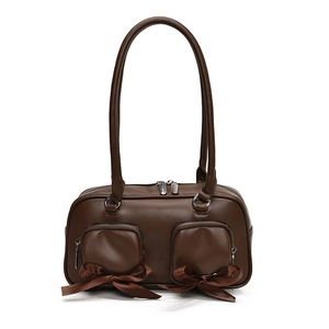Brown leather shoulder bag with chic front pockets and decorative ribbon bows