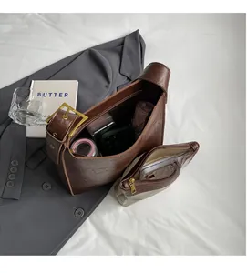 Detailed view showing the large capacity and inner pouch of this vintage brown hobo bag