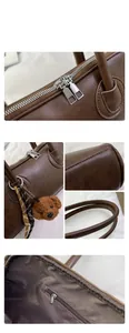 Detail of dark brown leather handbag with silver double zippers and plush puppy charm