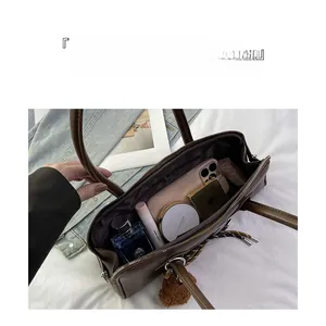Interior view showing the large capacity and organized compartments of the brown baguette bag