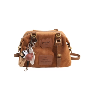 Brown suede Boston bag featuring large capacity design and luxury vintage textures