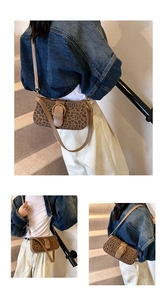 Detail of leopard print crossbody bag featuring brown leather trim and metallic oval buckle