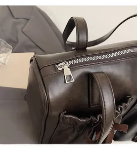 Detail of smooth silver zipper and matte dark brown leather on stylish shoulder bag
