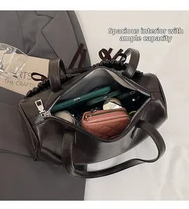 Detail view of the spacious interior of a dark brown bow shoulder bag with essentials