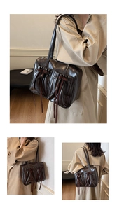 Close-up of vintage brown tote bag featuring pleated pockets and decorative bow details