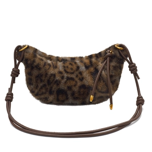 Detail of plush leopard print hobo bag with brown leather strap and gold ring buckles