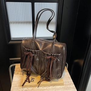 Vintage dark brown faux leather tote bag with pleated pockets and drawstring bow detail