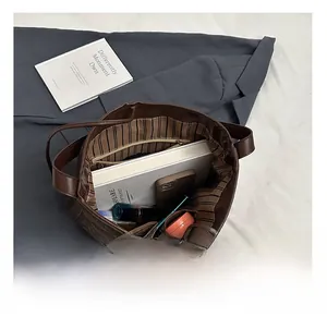 Top view showing the spacious striped interior and organizer pockets of this tote bag