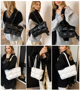 Detail showing the quilted nylon tote bag in black and white colors on a model