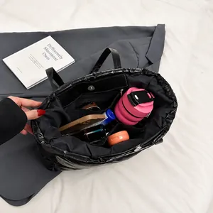 Top view of spacious black leather tote interior showing organizer pockets and daily items