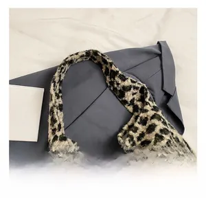 Detailed macro view of the thick plush leopard print handle and soft fabric texture