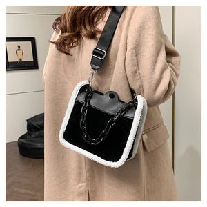 Detail of vintage plush shoulder bag with faux fur trim and chic acrylic chain decoration