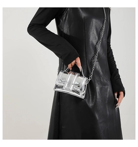 Mini silver mirror handbag with chain strap shown on black leather dress for contrast