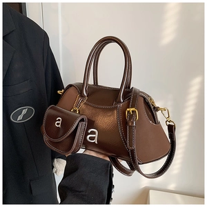 Brown faux leather Boston bag with mini charm pouch and adjustable shoulder strap