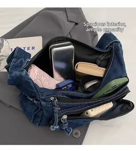 Spacious interior of denim messenger bag with pockets for phone and umbrella