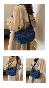 Detail of vintage blue denim messenger bag with multi-zipper layers and adjustable strap
