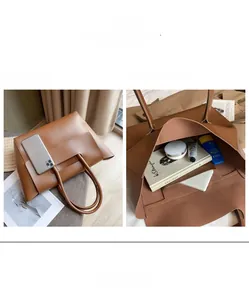 Detail view of large brown tote bag capacity compared to a smartphone and books
