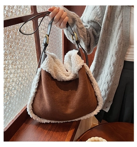 Detail of brown faux suede shoulder bag featuring plush white faux fur trim and gold metal ring